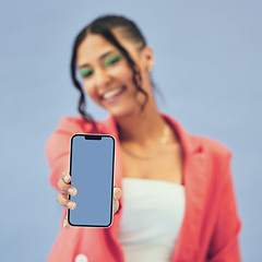 Image showing Phone screen, hands and happy woman in studio for mockup, news or social media on blue background. Smartphone, space and lady person show contact, promo or sign up, information or application process