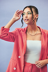 Image showing Woman, thinking and fashion with gen z style and trendy clothes with cosmetics. Studio, blue background and intern with makeup and confidence with stylish suit for internship and classy clothing