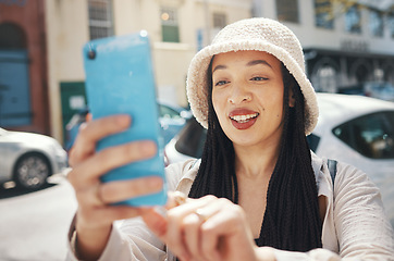 Image showing Happy woman on city street with phone, travel blog and live streaming for social media post on holiday. Influencer, streamer or gen z girl with urban fashion, smartphone and smile for content creator