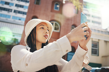 Image showing Woman on street with phone, live streaming in city and travel holiday blog for social media update. Influencer, streamer or gen z girl with urban fashion, smartphone and memory for content creation.