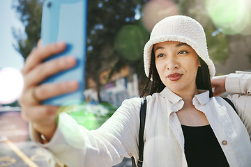 Image showing Woman on city street with selfie, travel blog and holiday memory for social media in streetwear. Influencer, streamer or gen z girl with urban fashion, photography or content creation with lens flare