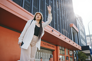 Image showing Road, walking and woman wave for taxi with travel, commute and ride in New York. Vacation, city street and urban with a female person with traveling and vacation on a trip for holiday adventure