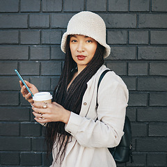 Image showing City, portrait and coffee with a cellphone, woman or social media with sms on black wall background. Person, face or girl with smartphone, mobile user or outdoor with digital app, contact or espresso