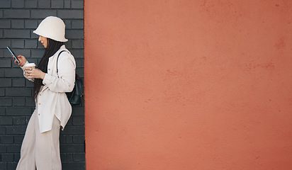 Image showing Woman with phone, brick wall and mockup, urban fashion and typing social media post, chat and coffee. Streetwear, gen z girl or online influencer with smartphone, communication and relax on red space