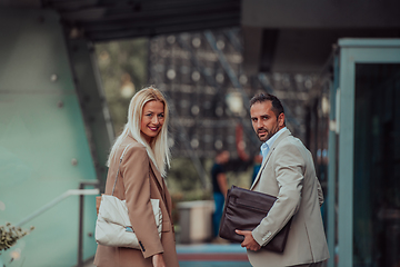 Image showing Modern business couple after a long day's work, walking together towards the comfort of their home, embodying the perfect blend of professional success and personal contentment.