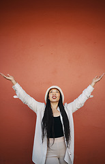Image showing Woman, fashion and arms up for wall and mockup space with urban style and trendy clothing. Freedom, hipster female person and modern confidence with red background and edgy gen z clothes of a girl