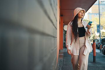 Image showing Street, walking and woman with phone and wall thinking about commute in the city. Road, urban sand female person with mobile text in New York with travel, journey and holiday adventure on solo trip