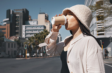 Image showing Coffee, travel and woman drink in city with trendy clothes for commute, walking and adventure. Relax, student and person with beverage, drinking and tea in town street for holiday, break and weekend