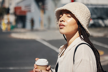 Image showing Coffee, travel and face of woman in city with trendy clothes for commute, walking and adventure. Relax, student and person with beverage, drink and tea in town street for holiday, break and weekend