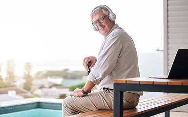 Image showing Headphones, patio and portrait of senior man by pool in backyard for relaxing, chill and podcast. Retirement home, happy and elderly person listening to music, streaming song and audio in summer