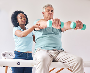 Image showing Old man, exercise and physiotherapy with dumbbell for wellness and muscle training on bed with black woman. Healthcare, physiotherapist and senior with workout for healing help, support and fitness