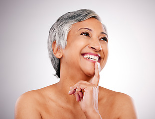 Image showing Face makeup, mature happy woman and thinking of anti aging, skincare idea or planning facial treatment. Studio, beauty solution and aesthetic model brainstorming self care routine on white background