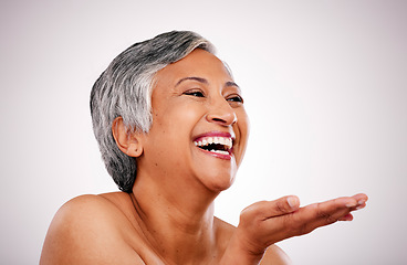 Image showing Skincare face, mature woman and laugh at funny anti aging treatment, self care shine or morning skin routine, hygiene or grooming. Studio comedy, makeup palm gesture and person on white background