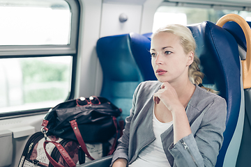 Image showing Blonde business woman traveling by train.