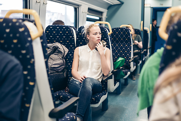 Image showing Woman travelling by train.