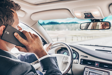 Image showing Man using cell phone while driving