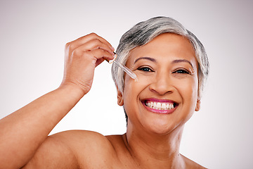 Image showing Beauty, portrait and mature happy woman with serum skin hydration, anti aging product or collagen oil for spa skincare treatment. Liquid dropper, hyaluronic acid and studio face on white background