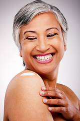 Image showing Body cream, shoulder and beauty of a mature woman with glow and smile on a white background. Dermatology, moisturizer and cosmetics of aesthetic model for skin shine, wellness or self care in studio