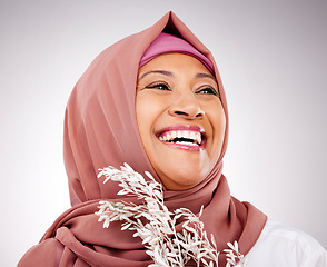 Image showing Skincare, plant and face of Muslim woman in studio with makeup, cosmetics and natural beauty. Dermatology, happy and Islamic person with flowers on gray background for organic wellness products