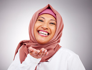 Image showing Blow kiss, happy and portrait of Muslim woman in studio with makeup, cosmetics and beauty. Fashion, style and face of Islamic person with hand gesture for love, affection or emoji on gray background