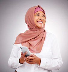 Image showing Muslim, phone and business woman with thinking and smile for career and vision with islamic company. Smartphone, person and employee in hijab or leader with corporate motivation and mindset in studio