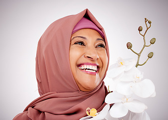Image showing Smile, thinking and Muslim woman with flowers in studio isolated on white background. Happy Islamic model with floral plant for skincare, orchid for healthy skin or organic makeup for beauty cosmetic