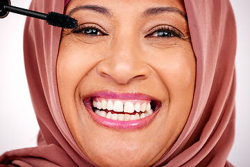 Image showing Portrait, Muslim woman and smile with makeup, mascara and cosmetics on a white studio background. Face, Islamic person and model with a hijab, dermatology and facial with a product, glow and shine