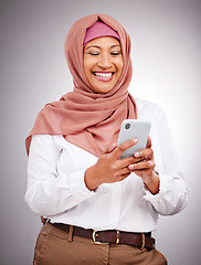 Image showing Muslim, phone and woman with smile in studio for social media scroll, internet post or mobile app on gray background. Smartphone, islam and person with happiness for technology, digital web or joy