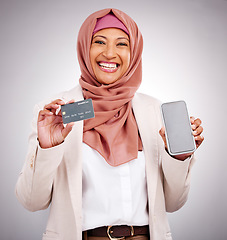 Image showing Muslim woman, ecommerce and credit card with a phone on a studio background for online shopping. Happy, portrait and an Islamic person with a mobile app for banking, finance management and payment