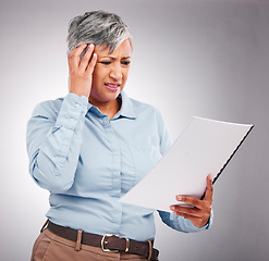 Image showing Business woman, headache and documents for financial stress, taxes error or payroll mistake in studio. Boss, accountant or confused executive with paperwork, pain and debt review on white background