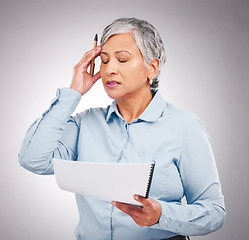 Image showing Business woman, headache and stress for documents, financial error, budget or taxes mistake in studio. Boss, accountant or confused executive with paperwork, pain and debt review on white background