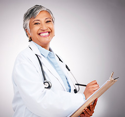 Image showing Happy, notes and portrait of woman or doctor writing feedback, healthcare advice or results. Smile, hospital and mature medical employee or nurse with insurance documents on a studio background