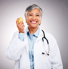 Image showing Woman, doctor and portrait with apple in studio for vitamin c benefits, health and care on grey background. Happy mature dietician, nutritionist and healthy food to lose weight with fruits for detox