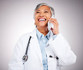 Image showing Doctor, phone call and woman in studio for communication, consulting or telehealth contact on grey background. Happy mature medical surgeon laugh for mobile consultation, support or healthcare advice