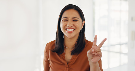 Image showing Business, portrait and happy woman with peace, hand or gesture with positive attitude in office. Face, smile and female manager with v, fingers or thank you, support or emoji, cool or expression