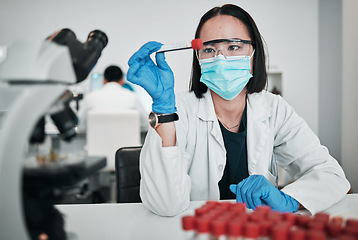 Image showing Scientist, blood test and woman in laboratory with face mask for studying medical analysis, inspection and vaccine development. Asian science technician with tube, dna assessment and investigation