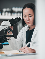 Image showing Microscope, asian woman and writing in laboratory for science development, planning analysis and research notes. Scientist, biotechnology and lens to review investigation, test report and dna results