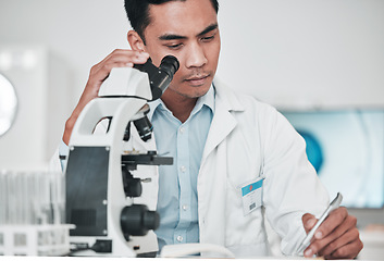 Image showing Scientist, microscope and man writing report, test results and research data for medical analysis of DNA in laboratory. Biotechnology, science and doctor with checklist, documents or healthcare study