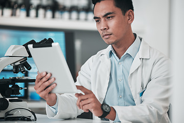 Image showing Scientist, man and tablet for laboratory research, data analysis and reading microscope results or test report. Doctor or medical expert on digital technology, science software and healthcare review
