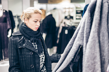 Image showing Beautiful woman shopping in clothing store.