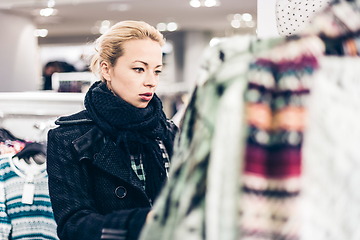 Image showing Beautiful woman shopping in clothing store.