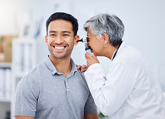 Image showing Doctor, patient or ear check for healthcare or wellness at hospital with otolaryngology specialist. Man, smile or senior physician woman with otoscope test for hearing problem or medical consultation