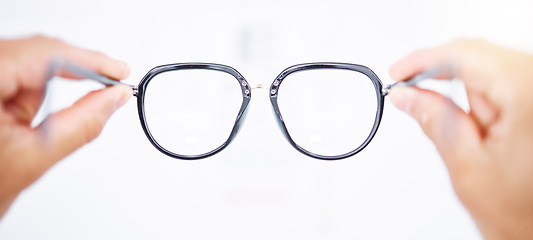 Image showing Glasses in hands, frame and vision for eye care, health and person for eyesight improvement, lens and perspective. Closeup, spectacles and optometry, designer eyewear and wellness on white background