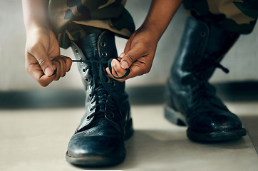 Image showing Hands tie shoes, closeup and soldier in army getting ready to start war, battle or fight. Boots, man tying laces in military and veteran preparing gear for training, exercise and workout to travel