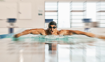 Image showing Swimming action, pool and sports man doing water challenge, cardio training or butterfly stroke action. Motivation, speed blur and swimmer workout, practice or training for competition, match or race