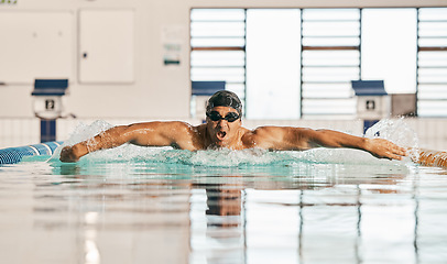 Image showing Swimming pool, water splash and sports man challenge, cardio training or butterfly stroke, action and fast motion. Fitness, commitment or swimmer workout, practice or training for competition race