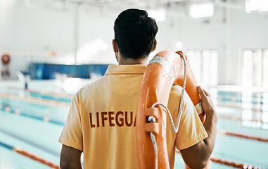 Image showing Lifeguard, back and person with swimming, pool or safety lifebuoy for rescue support, help or life saving. Surveillance attention, equipment and expert for protection, security or medical emergency