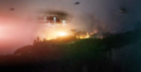 Image showing Night, ufo and spaceship in sky at forest in countryside, trees on fire and invasion in nature. Woods, flying saucer and spacecraft for extraterrestrial conspiracy theory, science fiction or fantasy