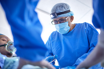 Image showing Scissors, hospital and surgeon team in theatre for emergency, healthcare or medical procedure. Doctors with a patient to start collaboration, surgery and operation with support and scrubs in ICU