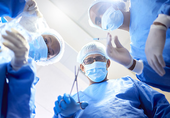 Image showing Hospital, tools and surgeon team in theatre for emergency, healthcare or medical procedure. POV, below and doctors for collaboration, portrait or surgery and operation with support and scrubs in ICU